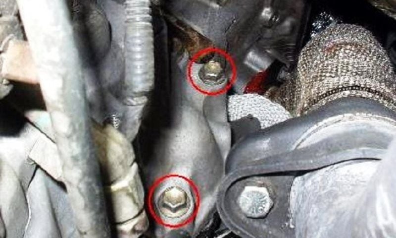Remove the two 12 mm mounting bolts from the starter