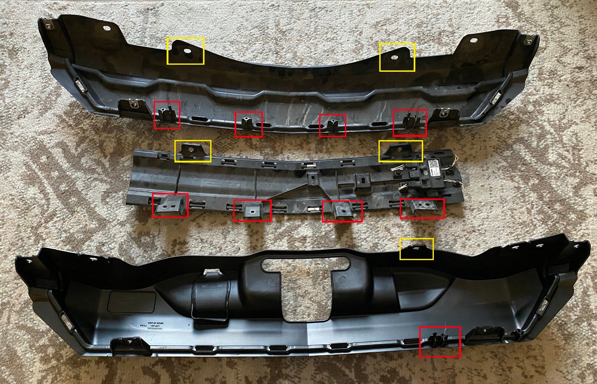 In this image the HFS module is removed for the original trim panel. The (red sections) show where the screw holes are to mount the module, and the (yellow sections) are where the plastic tabs are used to mount the module.