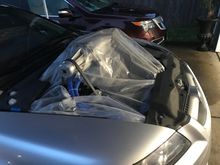 Going to cut the hood I reserved for the M90 Kit after tuning.

It’s raining a bit so I put an old shower curtain I had in my shed to keep the rain out. Put the engine covers over it to help keep it in place.

Think it will keep the rain out as I drive slowly to the tuning shop?