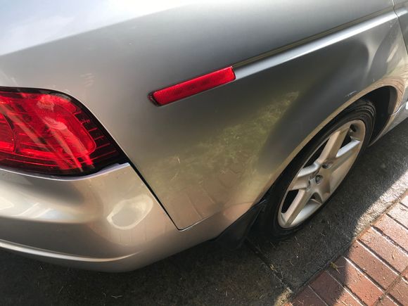 There is a dent that is evident indication structural damage. This right rear quarter panel must be put on a frame rack and pulled back out.