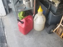 The can with the spout is for 2 stroke gas. The white one is for premium or diesel.