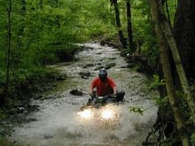 Riding down stream in the creek on our property.