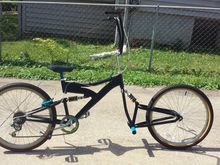 The product of 2 bikes together sporting a satin black finish with blue accent parts.