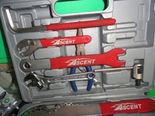The contents: lever arm for crank removal tool, pin spanner, pedal wrench adjustable wrench, chain tool, and needle nose pliers.