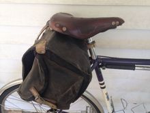 There is a small hole near the bottom of one of the side pockets from a couple of decades of a multi-tool bouncing around in there.  From this angle you can also see the auxiliary rivet (first attempted in 2014, updated and improved c.2017) fitted to keep the saddle in shape after the leather of the nose began tearing.