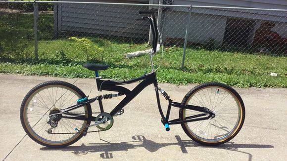 The product of 2 bikes together sporting a satin black finish with blue accent parts.