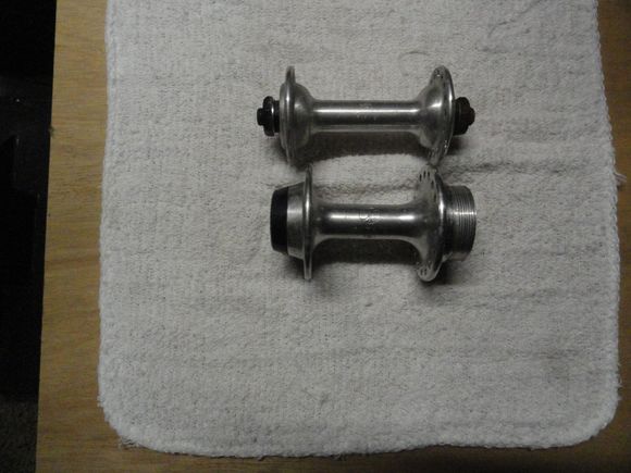 The rear axle and cones are in the parts washer.  I can scare up a pair of skewers for them and make a complete set for your build.