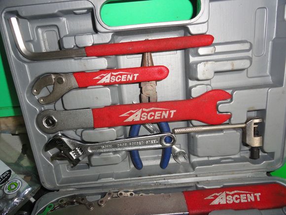 The contents: lever arm for crank removal tool, pin spanner, pedal wrench adjustable wrench, chain tool, and needle nose pliers.