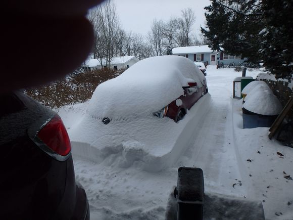 About a foot of snow where it didn't drift.  Gonna take some time to dig completely out.