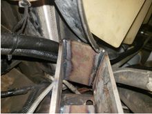 Looking up at the idler arm bracket and where I had to make a cut-out in the fan shroud for it.