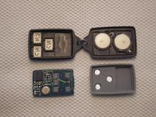 KE transmitter opened to access back of circuit board and actuator button contacts