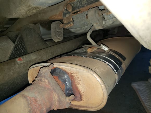 The hack job of extra aluminum on the top of the muffler.