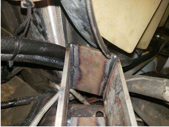 Looking up at the idler arm bracket and where I had to make a cut-out in the fan shroud for it.