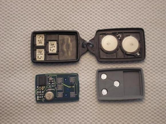 KE transmitter opened to access back of circuit board and actuator button contacts