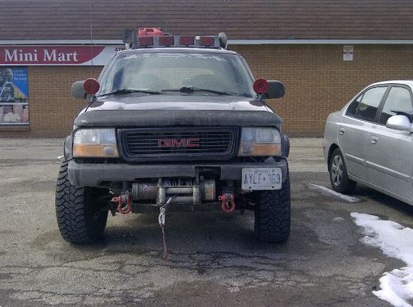 custom recivers with reciver shackles painted red,new black grill,jeep style mounted window lights for distance