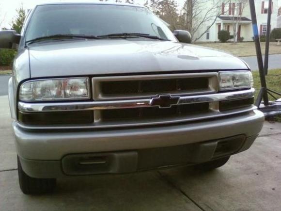 Front end, with the tinted turn signals, blacked grill, and black "bowtie."