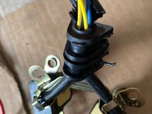 The rubber heat shield was torn at the top of the rubber grommet 