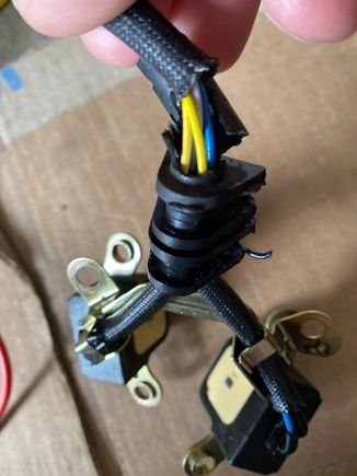 The rubber heat shield was torn at the top of the rubber grommet 