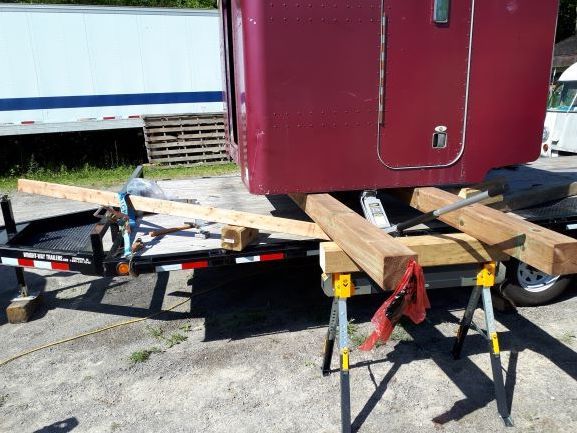 This side gave me a hard time. As I was lifting this side, the box wanted to lean forward and it kept me from getting the sawhorse under both 6x6 by myself. So, I had to come up with a solution to keep the one 6x6 up in the air that had the most load on in. 