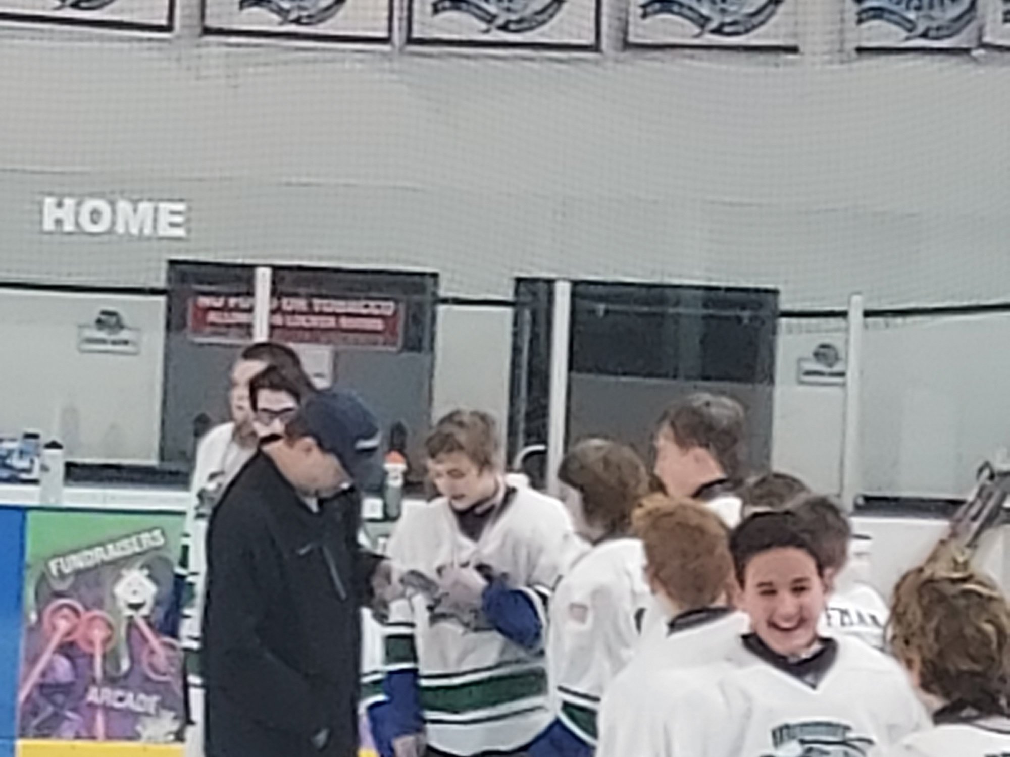 Gabe receiving his MVP medal from his Coach with teamates looking on