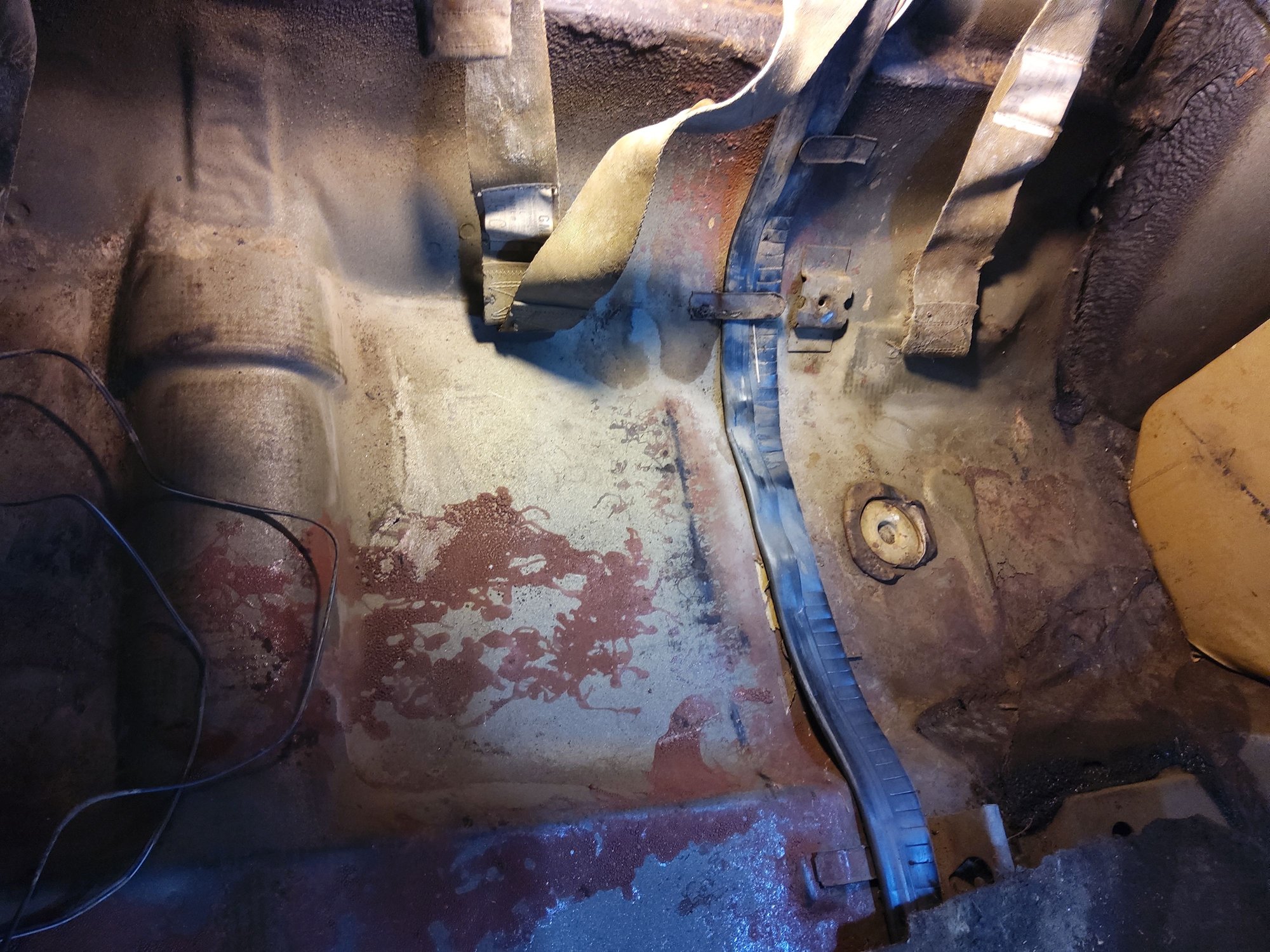 Rear seat area on the driver's side, I found it interesting that the factory didn't use all lof the cable hold down metal straps. 