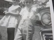 I think it is me and my sister.  Late fifties or early sixties when picture was taken.  We had a 58 ford wagon but the grill does not seem to match on the web.