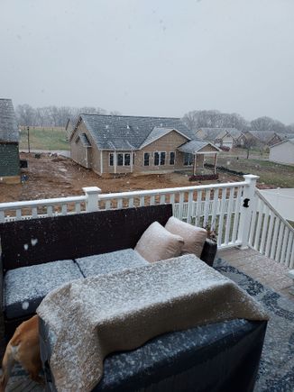 It's been snowing big ol flakes for awhile now, but it's just starting to stick on the raised surfaces, the ground is way to warm.