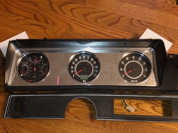 Here is the trial fit behind the factory gauge bezel (without the wood grain insert).  The turn signal and high beam indicators are in the center speedo gauge. I may mount 2 additional indicators in the bezel for parking brake and cruise.