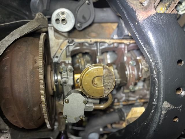 I had to raise it almost to where the transmission touched the floor pan to get the oil pan out.. Exhaust, shift linkage were removed, I loosened trans mount bolts to allow some flex.