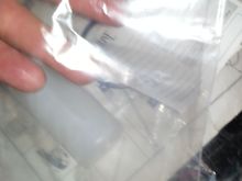Of course the plastic bag to go around the sample container that is under my hand