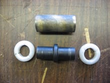Piece of oil impregnated brass bushing material, above original part.