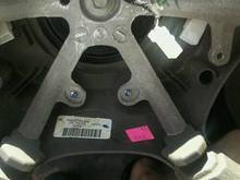 steering wheel that shows the white plug. Also note on the far right side that the metal tabs are where the air bag bolts in and just below that is the plastic housing where the switches screw in 