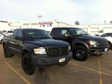 Finally have all the chrome gone. Added 16" V-Tec Raptor black rims. Speaking of Raptors look at my Dak put that one too shame, she ain't so "mid-sized" next to that f-1(shitty), really stands her ground. Also by this time I had added 2" blocks to the rear.