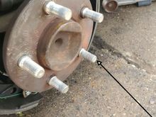 Arrow points to stripped wheel stud
