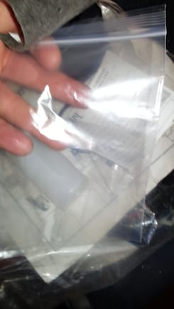 Of course the plastic bag to go around the sample container that is under my hand