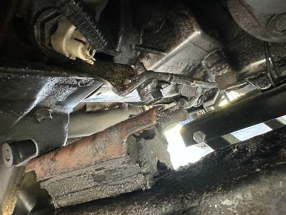 Lifted the trans up from the transfer case to see if it was separated. I don’t think the bolt is supposed to be separated from the transmission mount… 

Also noticed that as the truck was lifted, the shift linkage started pulling so it’s most likely what the problem has been. Going to replace the transmission mount and let y'all know how it goes after that!