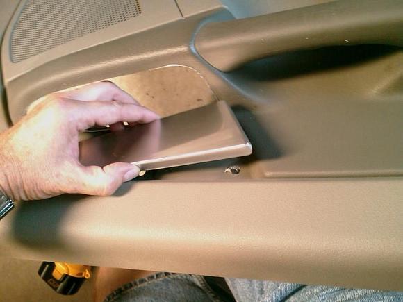 Here I am slowly pulling the trim panel out from the door panel.  Use 1/2" wood screws with some washers to hold the new panels in place...