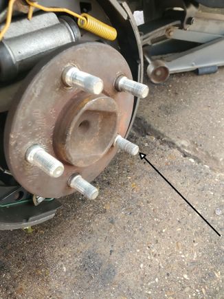 Arrow points to stripped wheel stud
