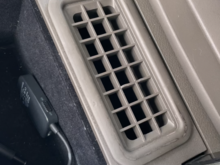 Anyone know how to pop up this vent insert so I can get at the screws beneath that are attaching the arm rest lid to the console? Can’t see any slits or areas to “pop” it up