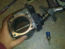 Dirty throttle body, old coolant sensor, and new thermostat.
