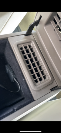Anyone know how to pop up this vent insert so I can get at the screws beneath that are attaching the arm rest lid to the console? Can’t see any slits or areas to “pop” it up
