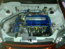 Added the Skunk2 spark plug cover after the valve cover was painted and installed the Spoon headers and strut bar.