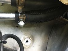 That bolt hole was for the washer fluid reservoir. I just routed the hoses up through the preexisting opening.


