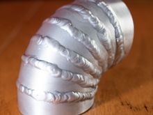 Yesterday's practice/attempt.  It will serve the purpose it needs to, but hopefully there's better to be done in the future.  This was with a 7.5* cut angle, and with just over a 1/8th inch inner width.  Tricky to weld those thin pieces!