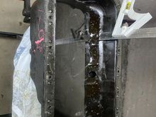 Here I did a test where I wanted to see where my oil line was. This is how much oil would be in a normal D16z6, and I have 2" of clearance to weld in my bung. Its right above the baffling. I have another photo of the inside of my current pan after the bung is welded on if that helps
