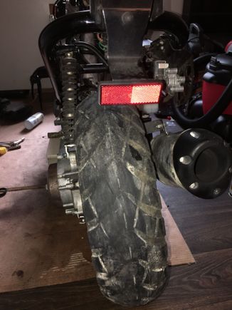 The bike is sitting level on a block. 
The rear tire cocked to the side and there is irregular wear. 