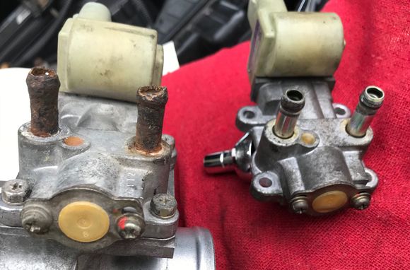 Salvaged IACV (L) with rusty coolant hose connectors vs. original IACV (R) 