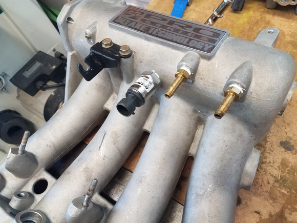 Hose barbs and boost gauge sensor installed on intake manifold.