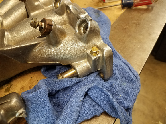 You can probably get away with just using a rubber cap, but I cut off the coolant nipple here where the small coolant line came from, tapped it, and threaded in an bolt with Permatex Ultra Grey on the threads - never had an issue with it like this.