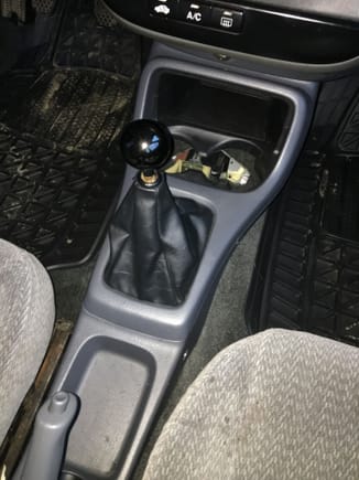 Shifter fits underneath the stock console